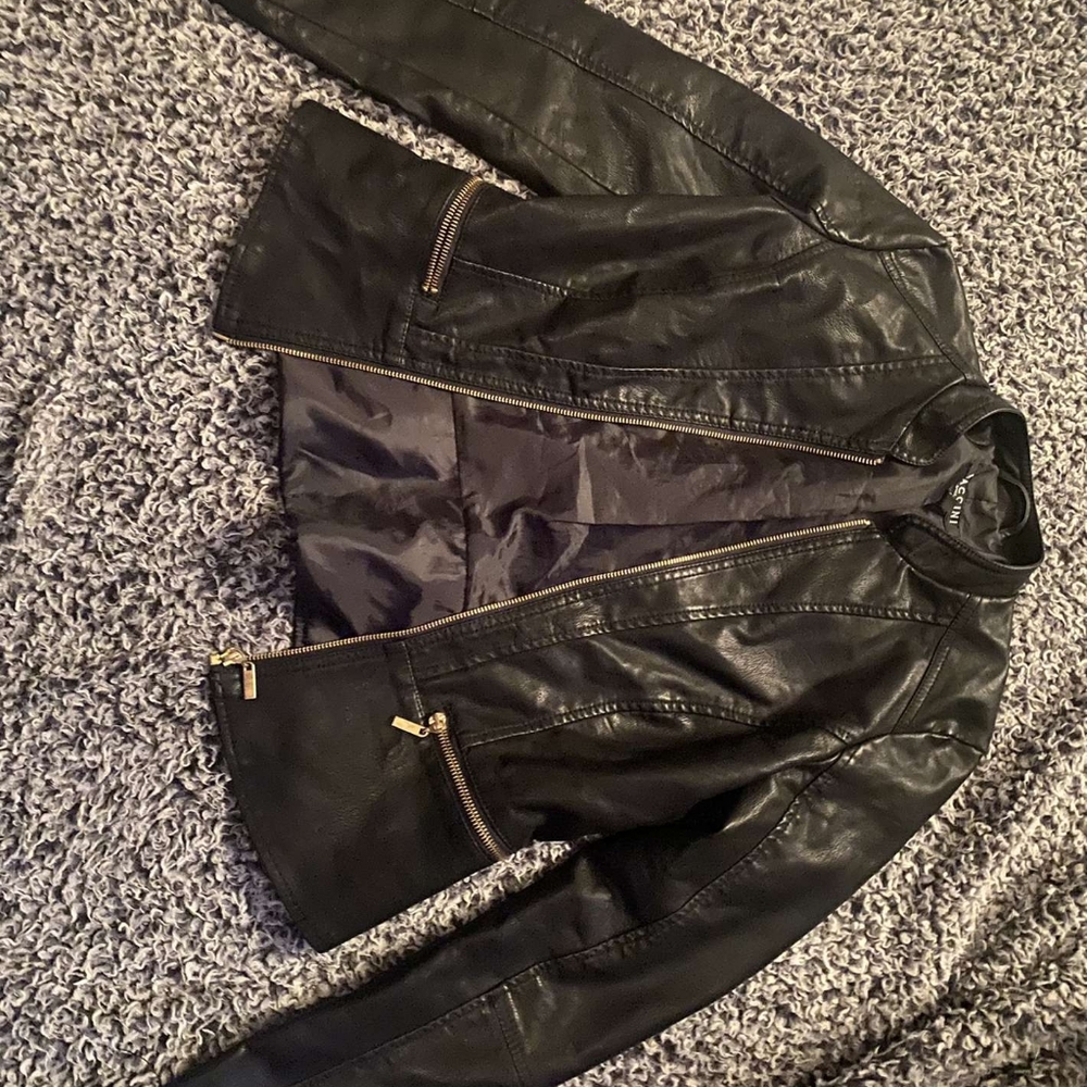 Black leather jacket with zipper pockets in front